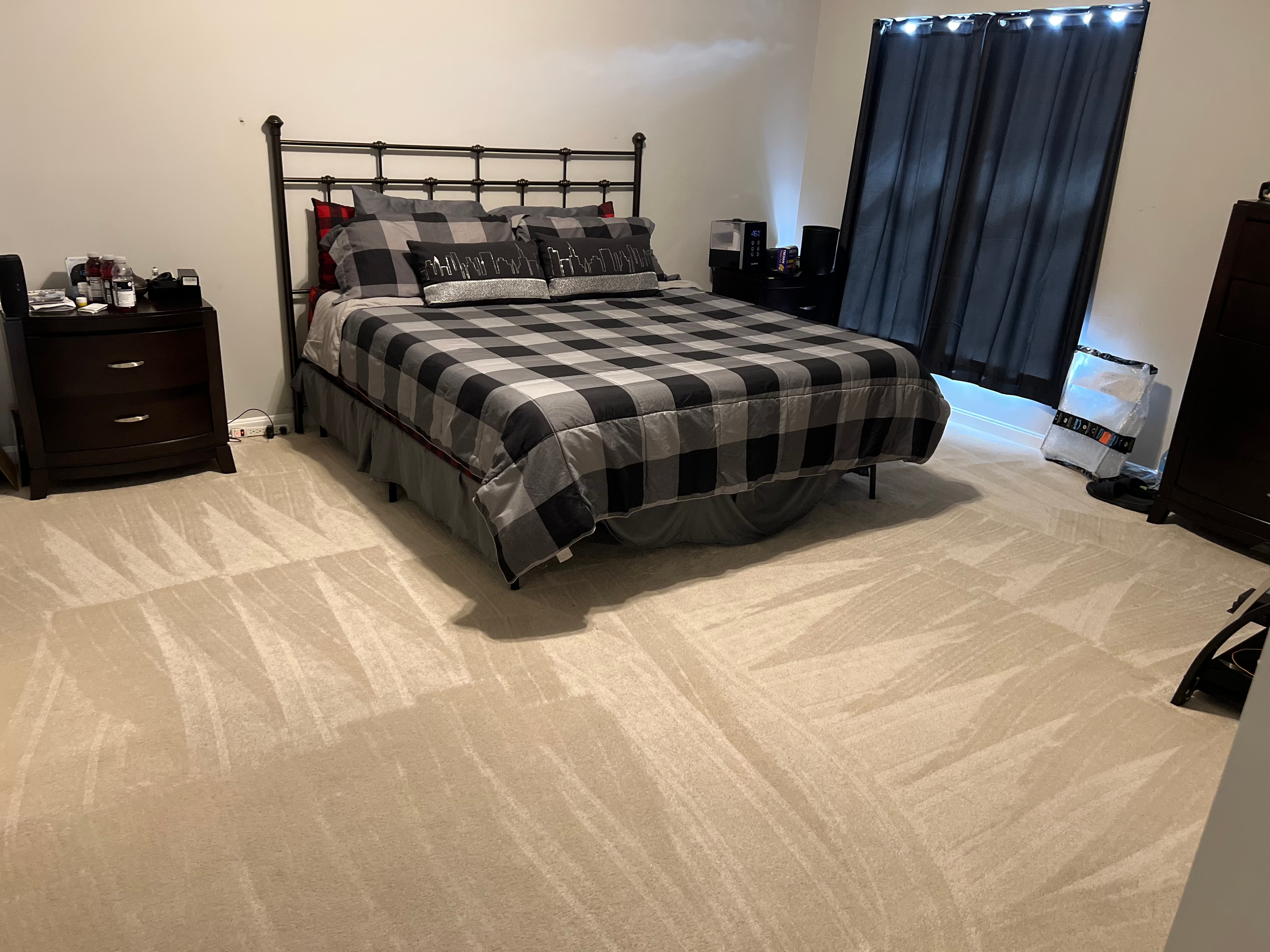 Bedroom after cleaning — fresh carpet, made bed, organized room