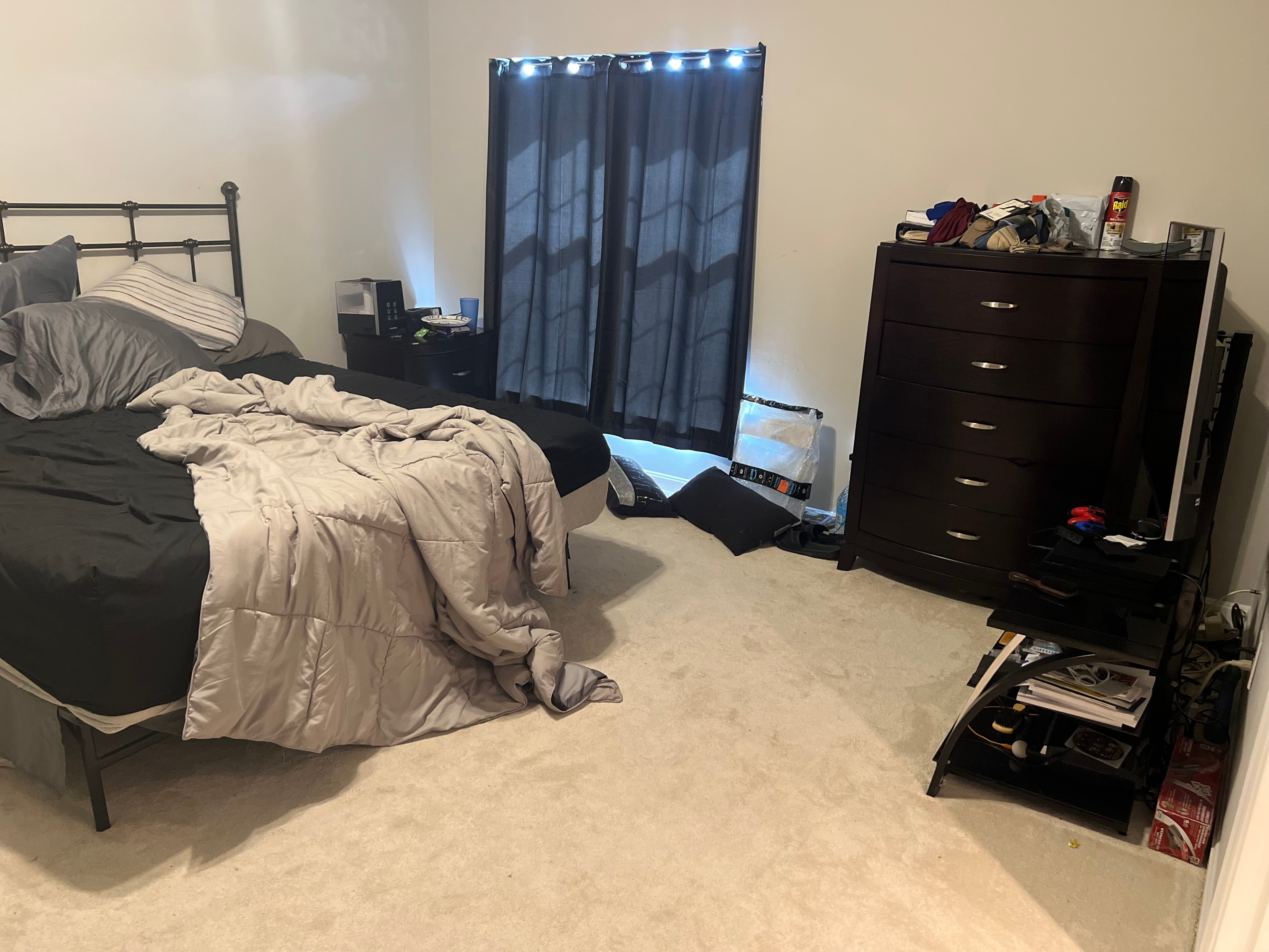 Bedroom before cleaning — messy with clutter on floor and dresser