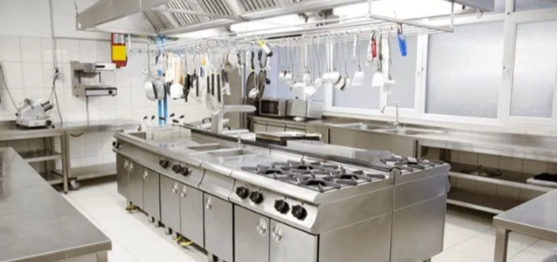 Technicians in blue gloves deep cleaning commercial kitchen equipment