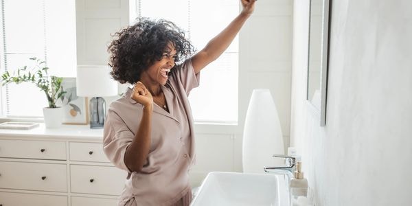 Happy homeowner celebrating a clean bathroom