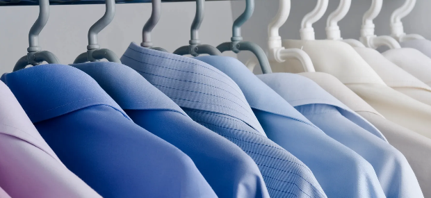 Clean dress shirts hanging on hangers after laundering